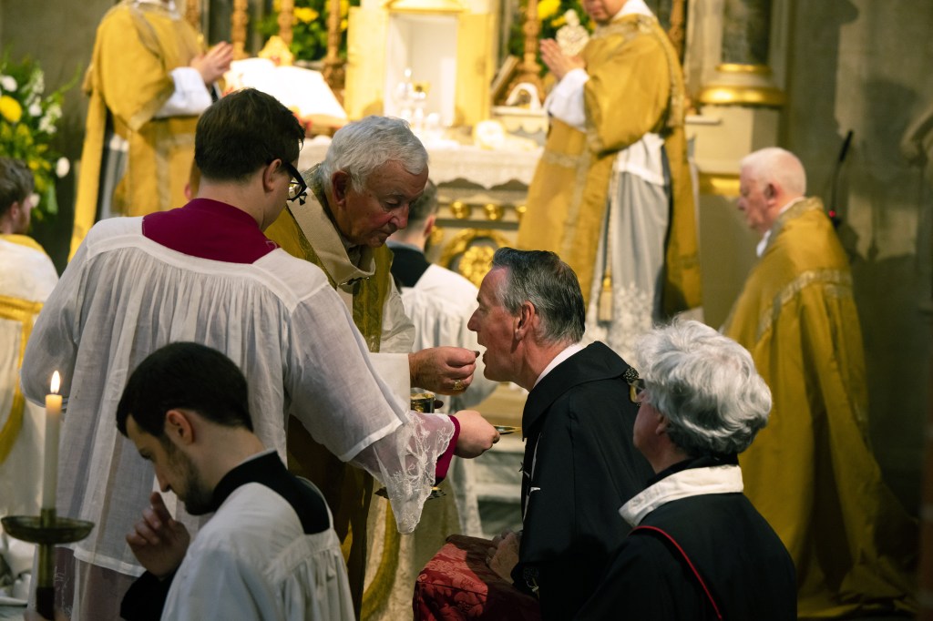 Cardinal Nichols gives Holy Communion to the Grand Prior of the Order of Malta